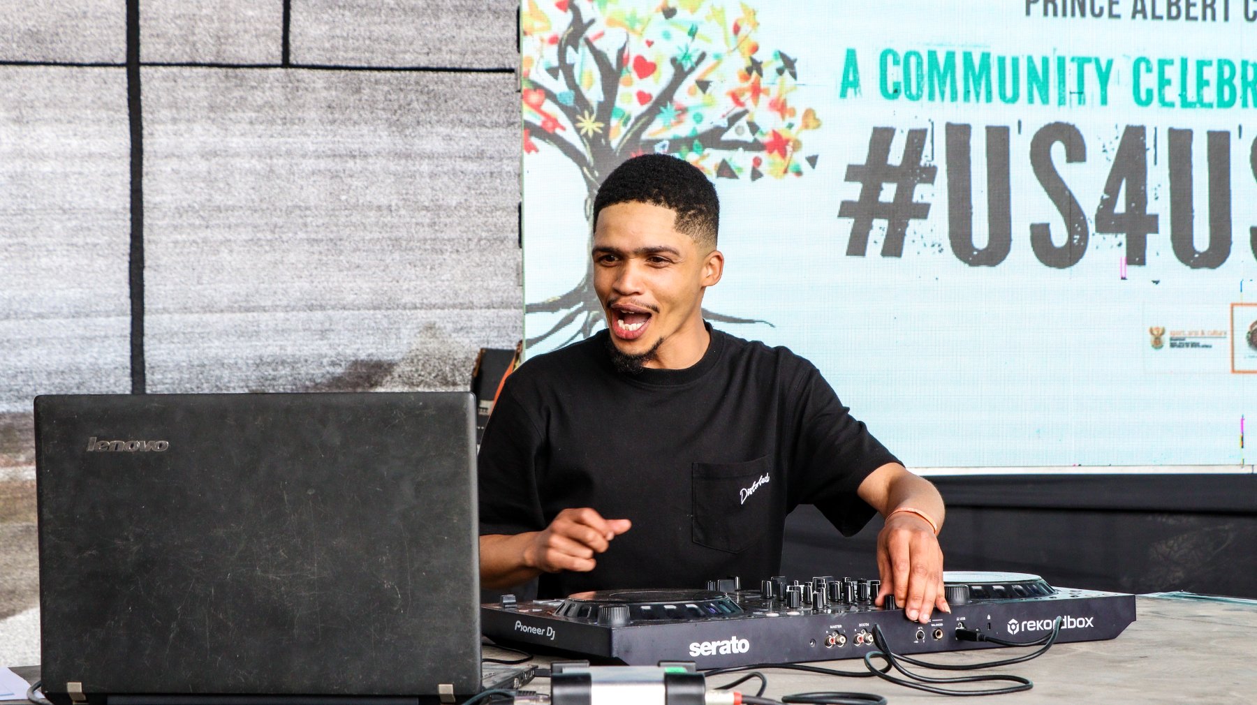 A DJ performing at a #us4us community celebration in Prince Albert